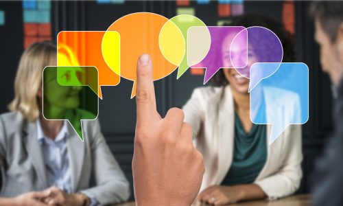 PRofessionals talking around a table with superimposed speech bubbles in multicolor Helping Students Learn Despite their Anxiety